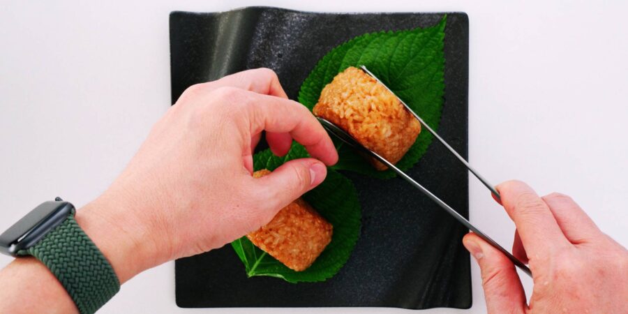 Plating Yaki Onigiri on top of Shiso leaves.