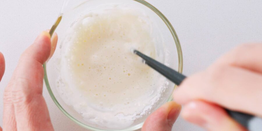 Preparing flour glue for sealing spring rolls shut.