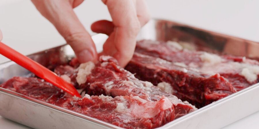 Marinating hanger steaks with ginger and garlic for beef teriyaki.