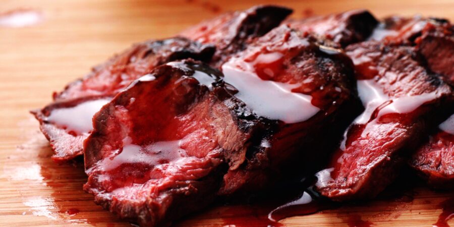 Closeup of grilled hanger steaks with shiny teriyaki sauce.