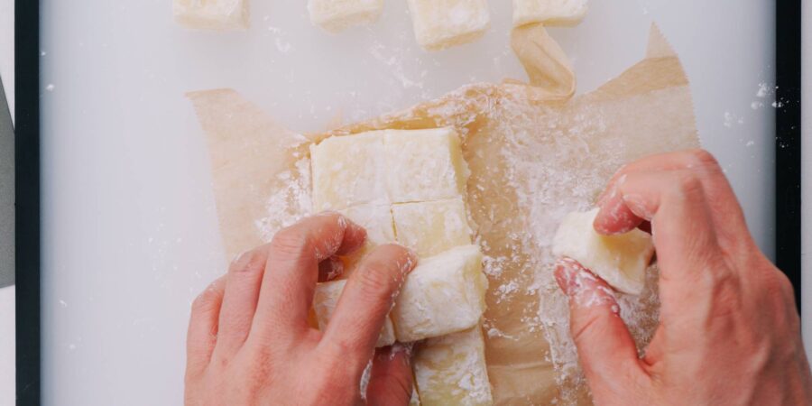 Dusting butter mochi with potato starch.