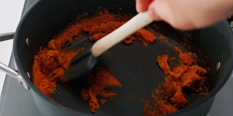 Curry powder and caramelized vegetable paste.