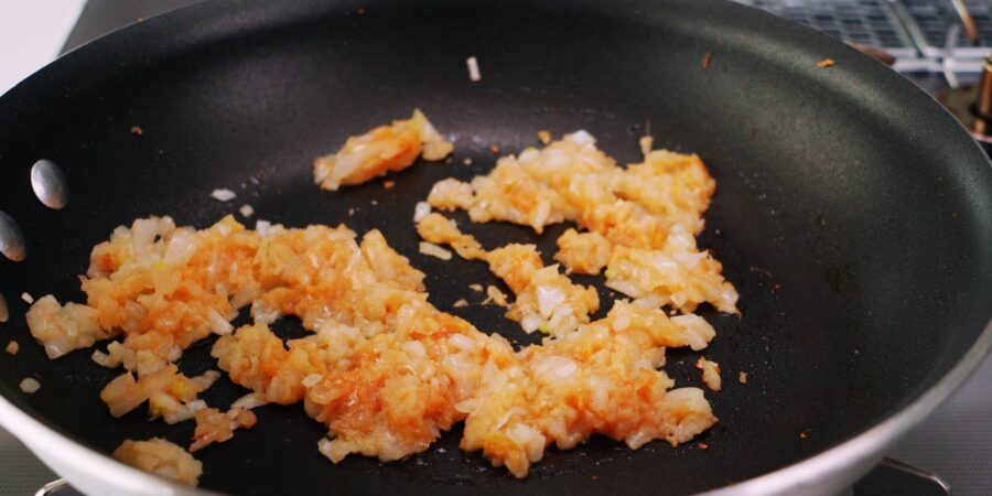 Sautéing ginger, garlic, onions, and miso for Mapo Tofu.