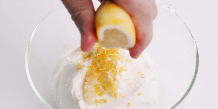Squeezing lemon juice into bowl of Mentaiko Sauce.