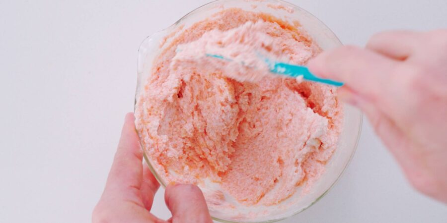 Mixing mentaiko bread spread in a glass bowl.