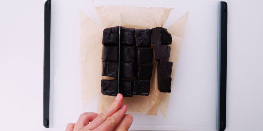 Cutting chocolate mochi up into squares.