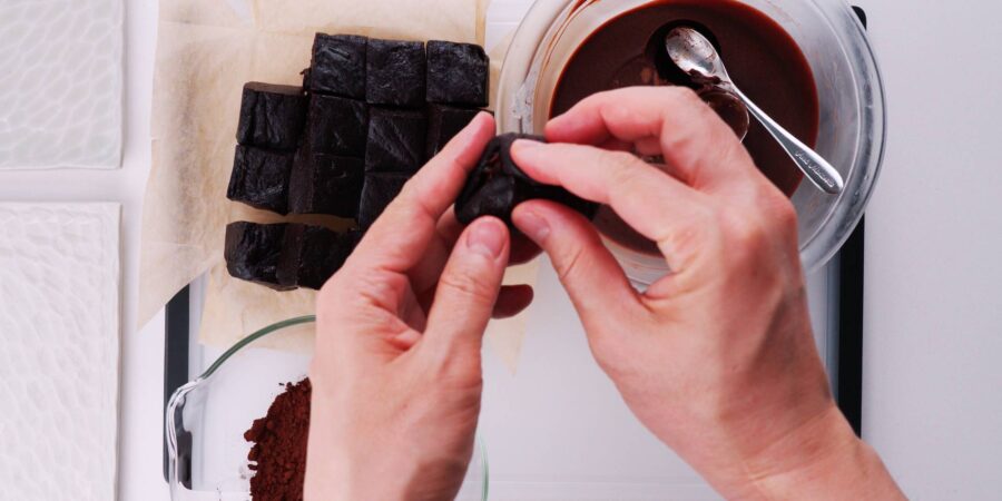 Stuffing chocolate mochi with ganache.