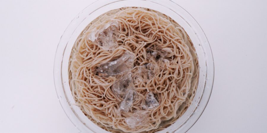 Chilling soba noodles in a bowl of ice water.