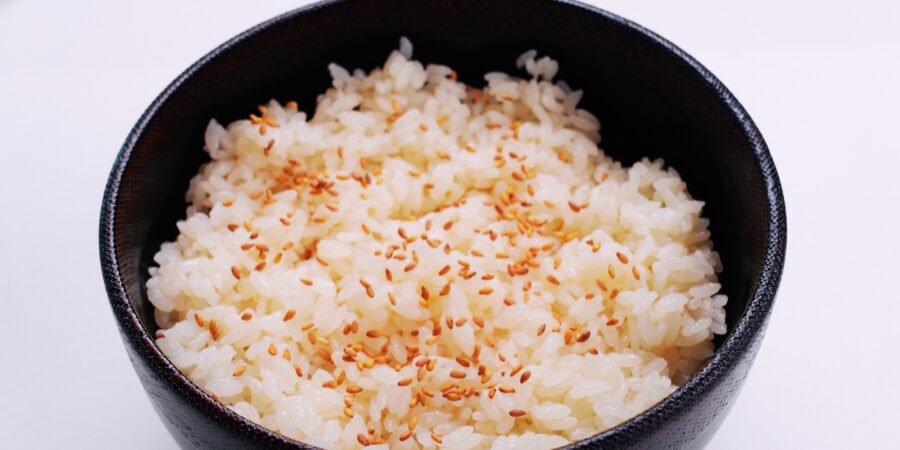 Bowls of sushi rice topped with toasted sesame seeds.