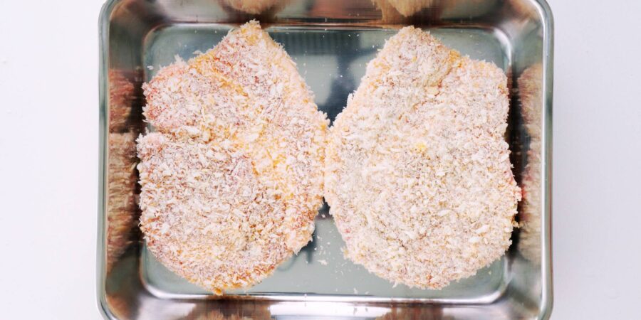 Breaded tonkatsu cutlets ready to fry.