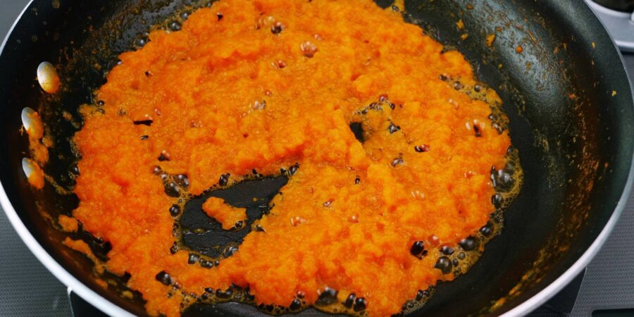 Burning off water from grated aromatics in a frying pan.