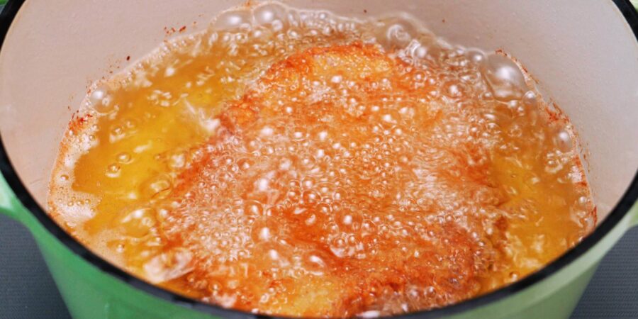 Deep frying pork cutlets to make Japanese Katsu Curry.