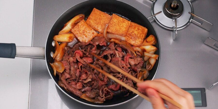 Simmering thinly sliced beef for making a Demon Slayer Beef Bento.