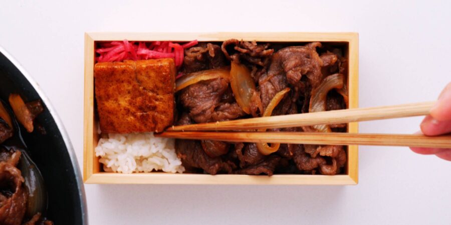 Adding benishōga and braised tofu to Rengoku's bento.