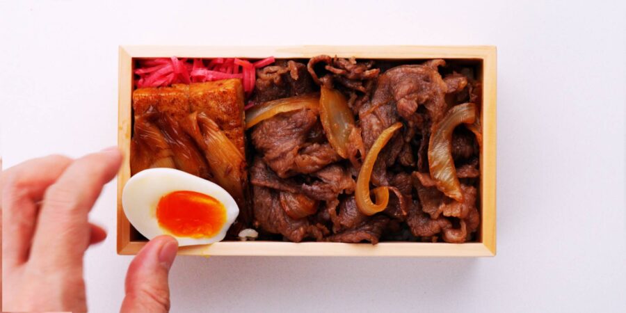 Finishing off the Demon Slayer beef bento with a boiled egg.