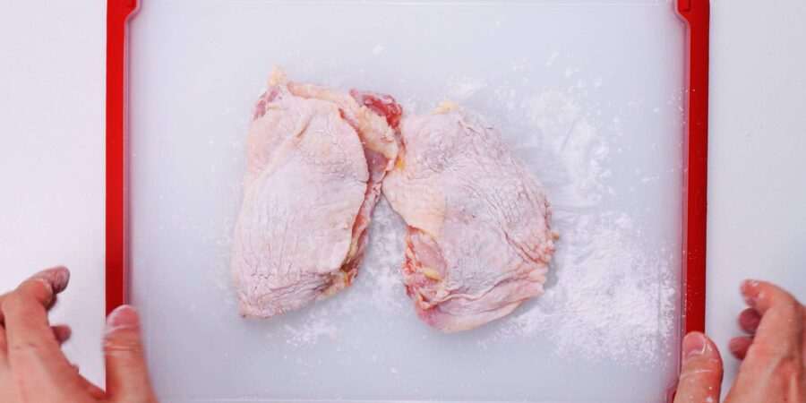 Dusting chicken with potato starch.