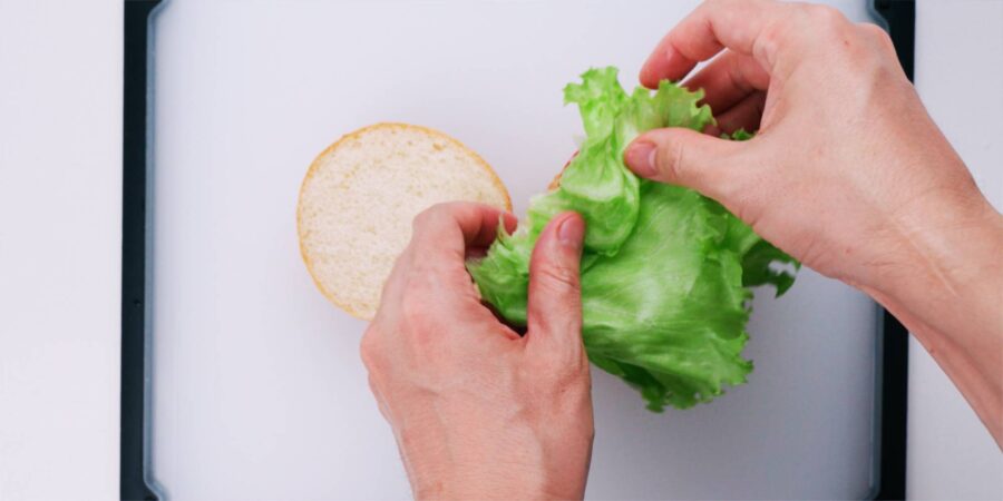 Add the lettuce to the sandwich.