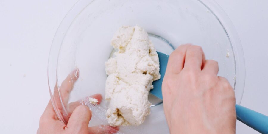 Kneading the tofu together with seasonings.