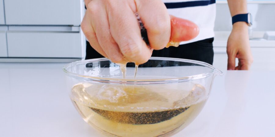 Squeezing shiitake mushroom stock from rehydrated mushrooms.