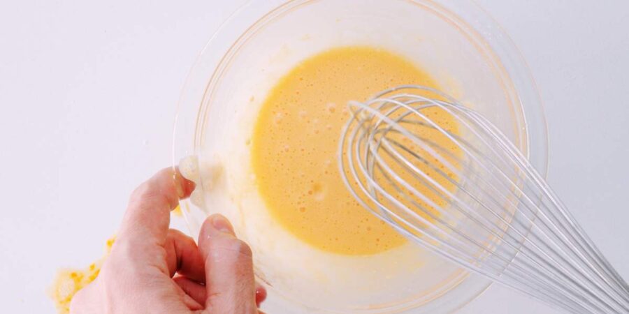 Whisking batter for deep fried oysters.