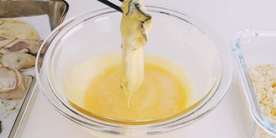 Dipping oysters in batter.