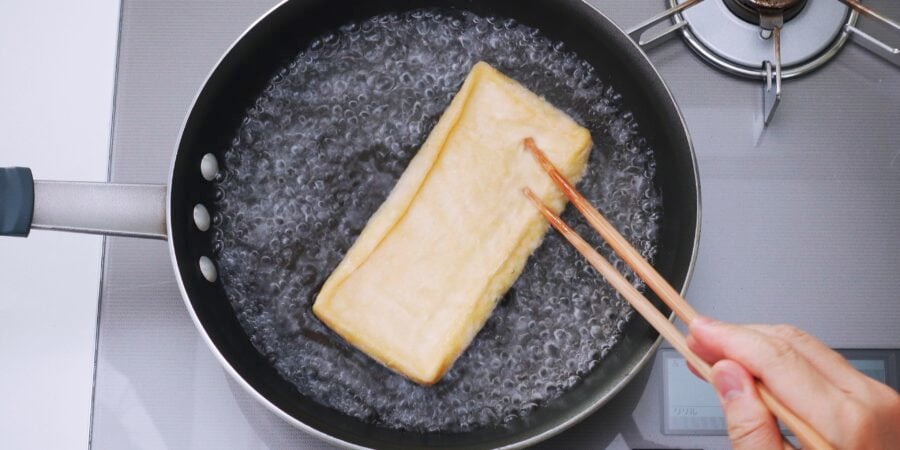 Boil the aburaage to get rid of any excess oil in the tofu.