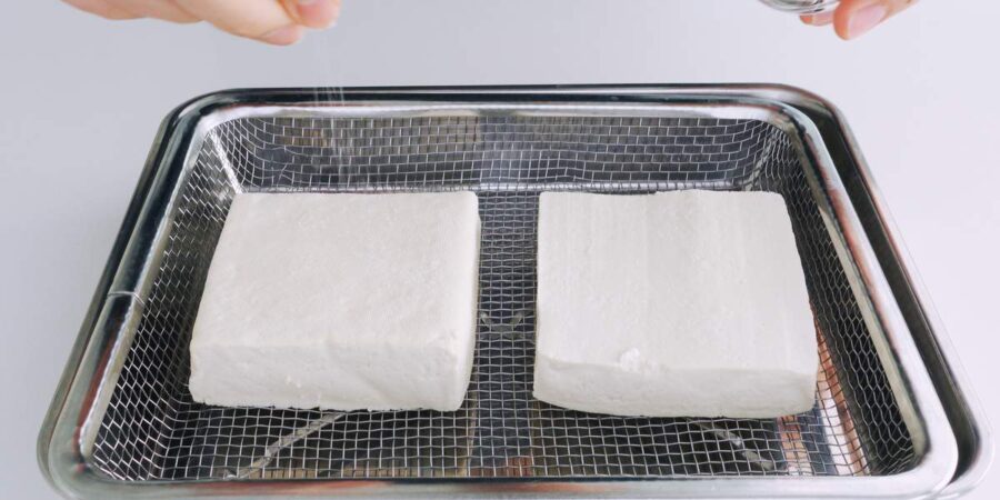 Tofu steaks being salted and drained.