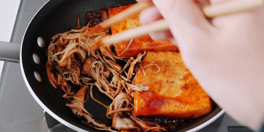 Coating mushrooms with steak sauce.