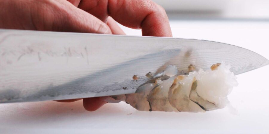 Cutting slits into shrimp.