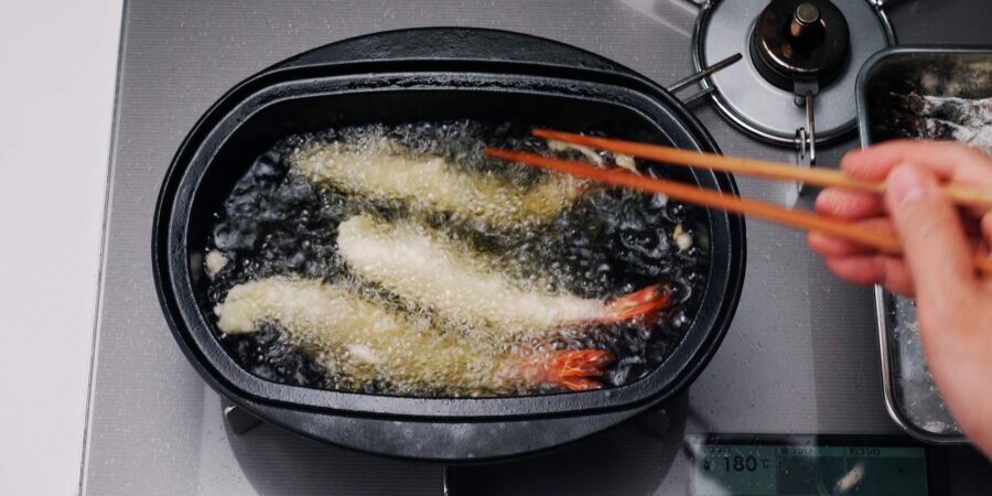 Flipping shrimp tempura over.