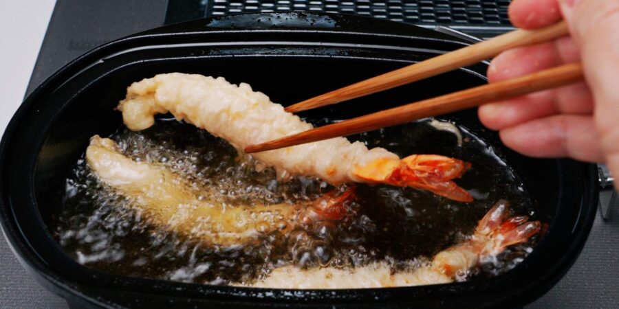 Frying tempura shrimp.
