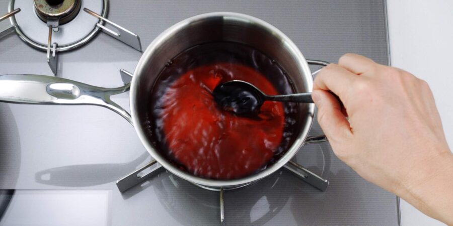 Udon broth boiling in a pot.