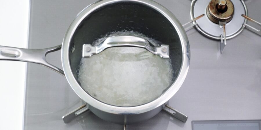 Bringing pot of rice and water to a boil.