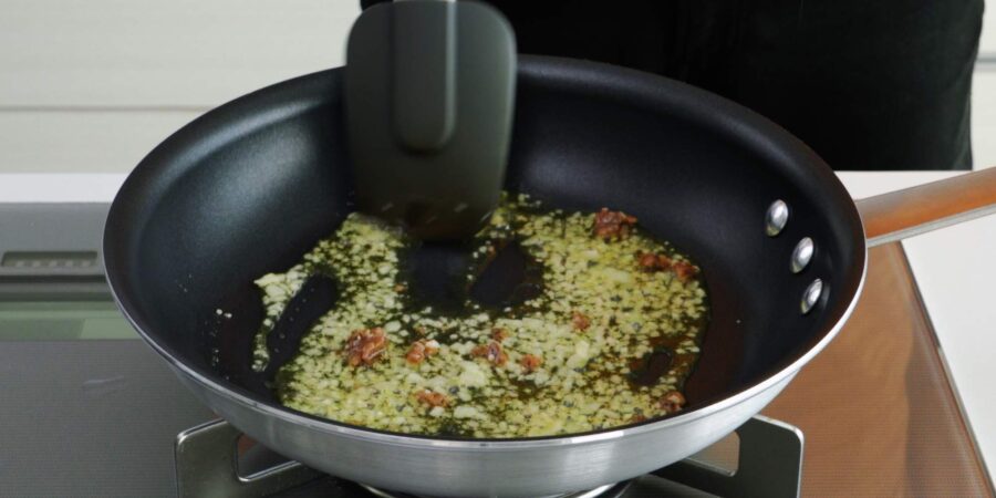 Sauteeing garlic and anchovies in olive oil.