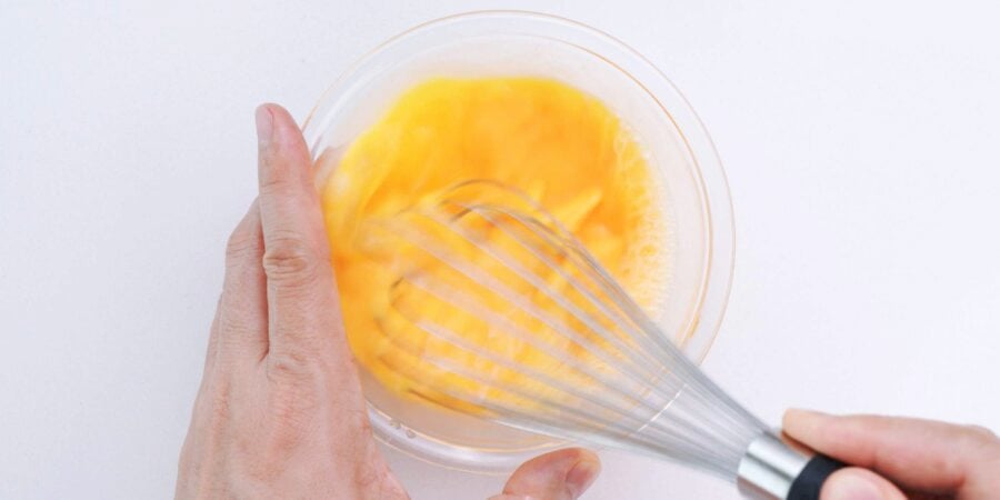 Whisking eggs and dashi together to make Okonomiyaki Batter.