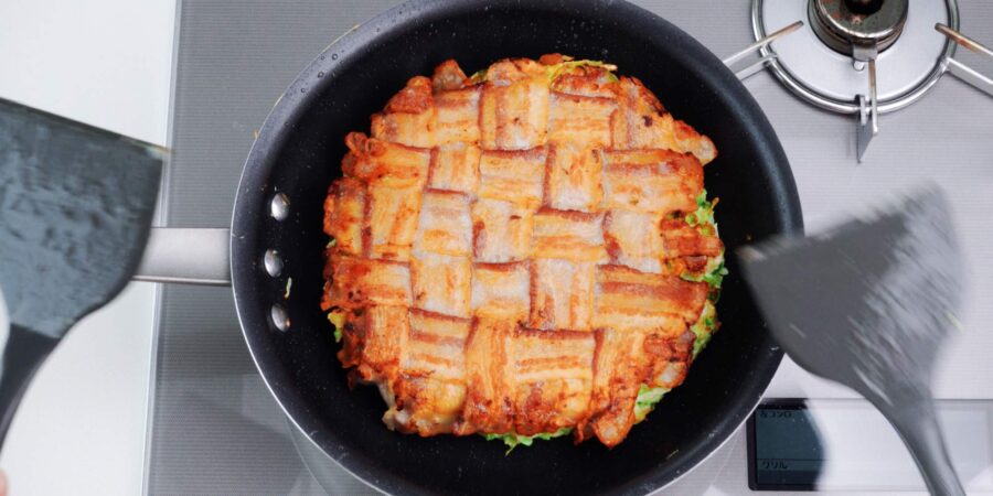 Japanese cabbage pancake topped with crispy pork belly.