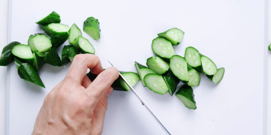 Slicing Japanese cucumbers into an oblique cut.