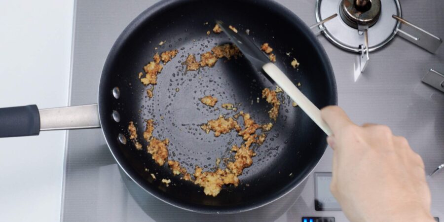 Ground Sichuan pepper and sugar in a frying pan.