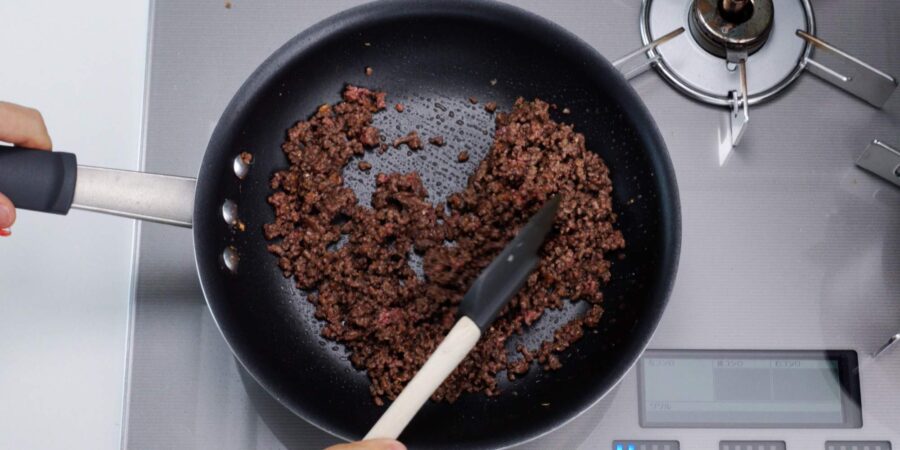 Browning beef in a frying pan.