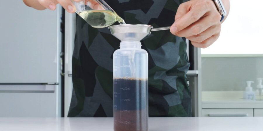 Adding sake to teriyaki sauce in a bottle.