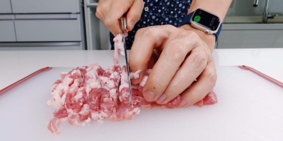 Hand mincing pork for korokke.
