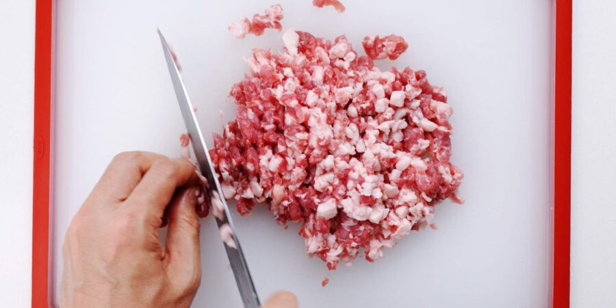 Mincing pork for croquettes.