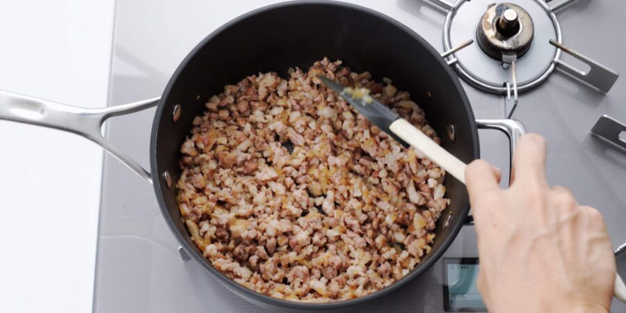 Sauteeing pork and onions for korokke filling.