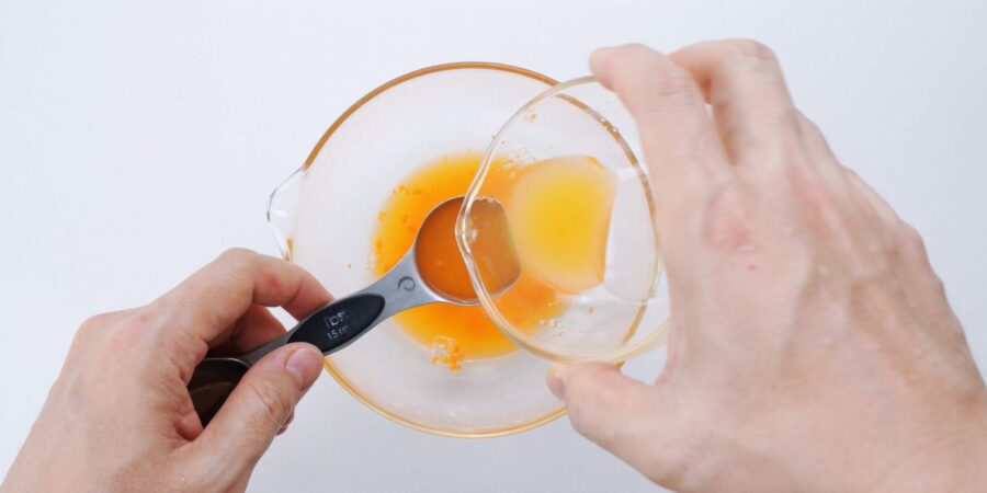 Measuring citrus juice into a glass bowl for making Ponzu.