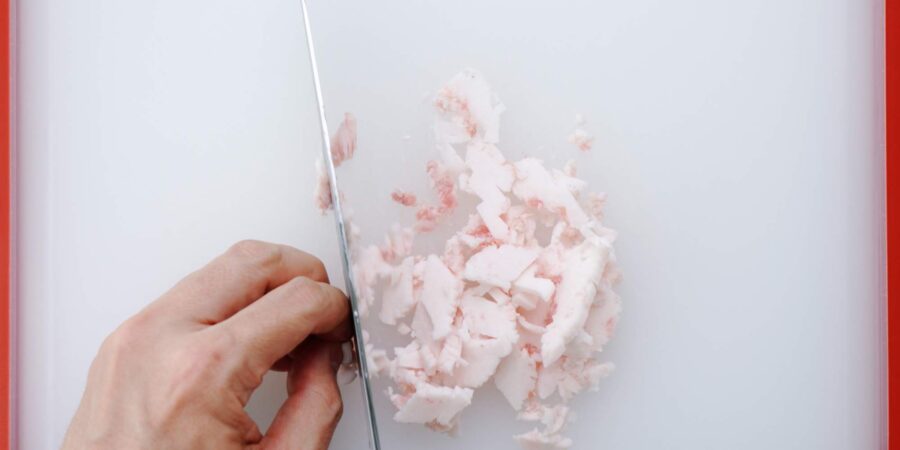 Chopping pork fat for Shumai dumplings.