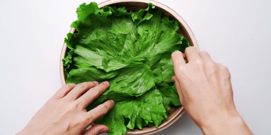 Bamboo steamer lined with lettuce leaves.