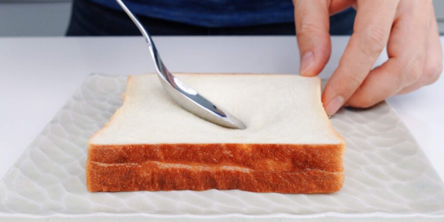 Press indentation into the bread to hold the egg.