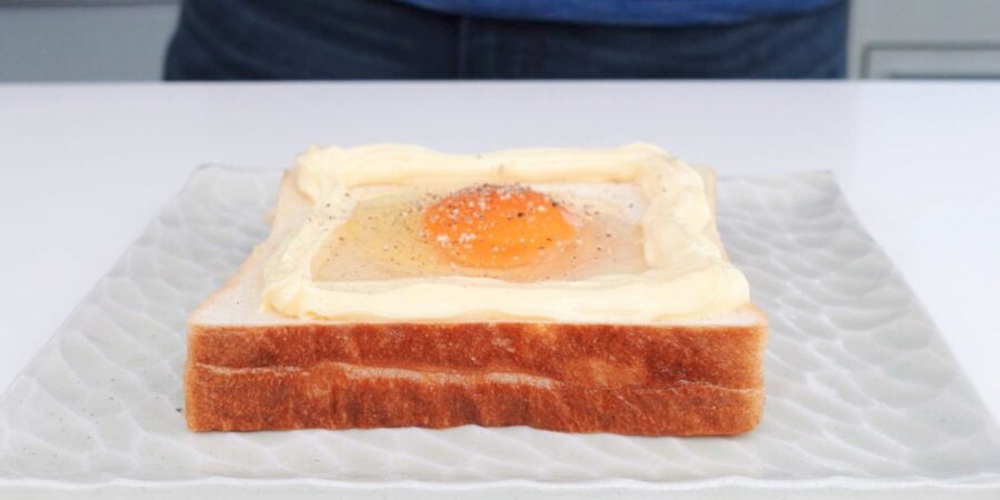 Add egg on top of toast and season with salt and pepper.