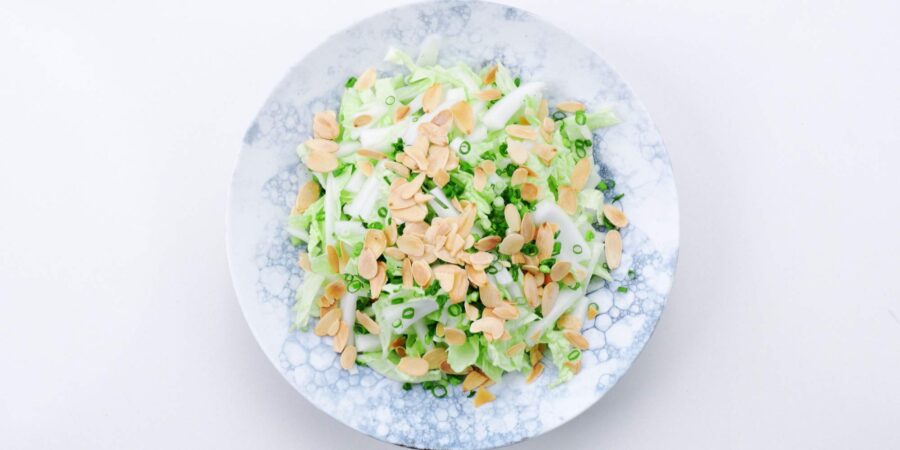 Shredded napa cabbage topped with toasted almonds and scallions.