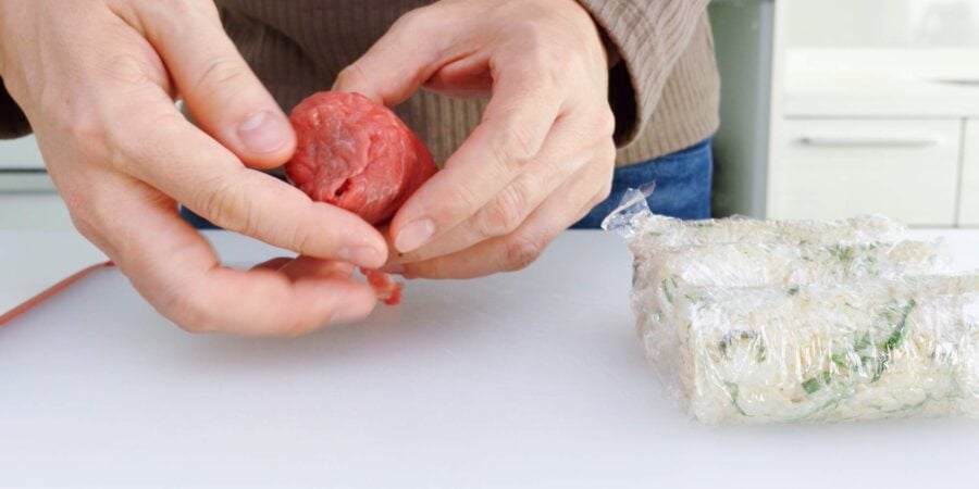 Tucking the ends of meat wrapped onigiri.